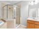 Bathroom featuring a glass shower, a bathtub, and a wood cabinet with sink and a big mirror at 12820 Belvedere Song Way, Riverview, FL 33578