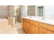 Bathroom features a double vanity, tub, and a glass enclosed shower at 12820 Belvedere Song Way, Riverview, FL 33578