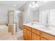Bathroom features double sink vanity, glass shower, and soaking tub at 12820 Belvedere Song Way, Riverview, FL 33578