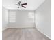 Bright bedroom featuring a carpeted floor, ceiling fan and two bright windows at 12820 Belvedere Song Way, Riverview, FL 33578