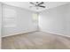 Bright bedroom featuring a carpeted floor, ceiling fan and two bright windows with blinds at 12820 Belvedere Song Way, Riverview, FL 33578