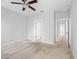 Spacious bedroom featuring a carpeted floor, ceiling fan and open doorway to the hallway at 12820 Belvedere Song Way, Riverview, FL 33578