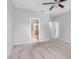 Spacious bedroom showcasing a carpeted floor, ceiling fan and open doorway to the bathroom at 12820 Belvedere Song Way, Riverview, FL 33578