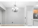 Dining area with chandelier, tile floors, and open access to kitchen at 12820 Belvedere Song Way, Riverview, FL 33578