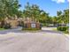 Community entrance with brick sign, black iron gates, and well-maintained landscaping on a sunny day at 12820 Belvedere Song Way, Riverview, FL 33578