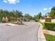 View of community entrance with brick pillars, signage, and lush landscaping along the road at 12820 Belvedere Song Way, Riverview, FL 33578