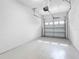 Garage featuring epoxy flooring and garage door opener at 12820 Belvedere Song Way, Riverview, FL 33578