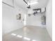 Spacious garage with epoxy flooring, water heater, and door access at 12820 Belvedere Song Way, Riverview, FL 33578