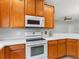 Kitchen featuring white appliances and countertops with plenty of cabinet space at 12820 Belvedere Song Way, Riverview, FL 33578