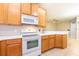 Cozy kitchen featuring wooden cabinets, modern appliances, and a bright, open design at 12820 Belvedere Song Way, Riverview, FL 33578
