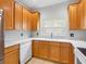 Beautiful kitchen featuring wooden cabinets, white appliances, and a double basin sink at 12820 Belvedere Song Way, Riverview, FL 33578