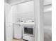 Laundry closet featuring a modern washer and dryer, and an open doorway at 12820 Belvedere Song Way, Riverview, FL 33578