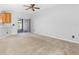 Bright, spacious living room with neutral carpet and a sliding glass door at 12820 Belvedere Song Way, Riverview, FL 33578