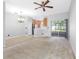 Open-concept living area with kitchen, chandelier and sliding glass doors at 12820 Belvedere Song Way, Riverview, FL 33578