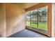 Enclosed patio with screen windows and a view of the manicured backyard and lush green lawn at 12820 Belvedere Song Way, Riverview, FL 33578