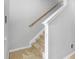 Carpeted staircase with wooden handrail and painted banister at 12820 Belvedere Song Way, Riverview, FL 33578