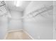 Walk-in closet with carpeted floor, white walls and white wire shelving at 12820 Belvedere Song Way, Riverview, FL 33578