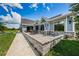 Inviting outdoor patio with a gray brick and blue siding, perfect for enjoying meals and entertaining guests at 16006 Shinnecock Dr, Odessa, FL 33556