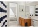 Bathroom featuring modern fixtures, wood vanity, and a view to the primary bedroom at 4206 Branchside Ln, Wesley Chapel, FL 33543
