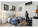 Comfortable bedroom featuring a hockey theme, light wood floors, and ample natural light at 4206 Branchside Ln, Wesley Chapel, FL 33543