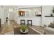 Open-concept living space with wood floors, bar seating, and view to entry at 4206 Branchside Ln, Wesley Chapel, FL 33543