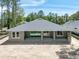 Rear elevation featuring covered patio and ample space for outdoor living at 4729 Majestic Hills Loop, Brooksville, FL 34601