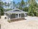 Side exterior of home with stone accents, window, and paved driveway at 4729 Majestic Hills Loop, Brooksville, FL 34601