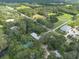 Aerial view of property showing home and surrounding land near waterway at 12805 Flint Creek Rd, Thonotosassa, FL 33592