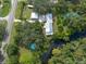 Aerial view of home near waterway with detached garage and pool at 12805 Flint Creek Rd, Thonotosassa, FL 33592
