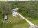 Aerial view of a home with a large yard and detached garage at 12805 Flint Creek Rd, Thonotosassa, FL 33592