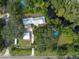 Aerial view of home with detached garage, pool, and lush landscaping at 12805 Flint Creek Rd, Thonotosassa, FL 33592
