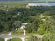 Aerial view showing home, detached garage, and surrounding lush landscape at 12805 Flint Creek Rd, Thonotosassa, FL 33592