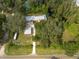 Aerial view of a home with detached garage and large lot near a waterway at 12805 Flint Creek Rd, Thonotosassa, FL 33592
