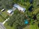 Aerial view of home with detached garage and pool near a waterway at 12805 Flint Creek Rd, Thonotosassa, FL 33592