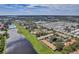Aerial view of community near a lake, showcasing various homes and landscape at 1308 13Th Se Cir, Largo, FL 33771