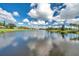 Tranquil lake view of the community with clear skies at 1308 13Th Se Cir, Largo, FL 33771