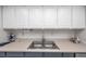 Modern kitchen with stainless steel appliances and blue cabinets at 1308 13Th Se Cir, Largo, FL 33771