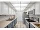 Modern kitchen with stainless steel appliances and blue cabinets at 1308 13Th Se Cir, Largo, FL 33771