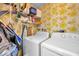 Laundry room with washer, dryer, and shelving for storage at 1308 13Th Se Cir, Largo, FL 33771