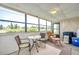 Relaxing screened porch with seating and view of the outdoors at 1308 13Th Se Cir, Largo, FL 33771