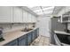 Modern kitchen with stainless steel appliances and blue cabinets at 1308 13Th Se Cir, Largo, FL 33771