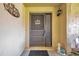 Condo's front door with a welcome mat and decorative accents at 1308 13Th Se Cir, Largo, FL 33771