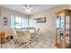 Bright dining area with wood-look flooring and view to the outdoors at 1308 13Th Se Cir, Largo, FL 33771