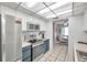 Modern kitchen with stainless steel appliances and blue cabinets at 1308 13Th Se Cir, Largo, FL 33771