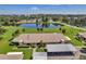 Complex of condo buildings near a lake with lush green surroundings at 1308 13Th Se Cir, Largo, FL 33771