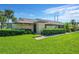 Condo exterior with a well-maintained lawn and landscaping at 1308 13Th Se Cir, Largo, FL 33771
