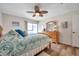 Bedroom with a queen bed, dresser, and ceiling fan at 1308 13Th Se Cir, Largo, FL 33771