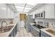 Modern kitchen with stainless steel appliances and blue cabinets at 1308 13Th Se Cir, Largo, FL 33771