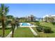 Community pool with lush landscaping and waterfront views at 50 Coe Rd # 322, Belleair, FL 33756