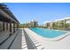 Inviting community pool with pergola and lounge chairs at 50 Coe Rd # 322, Belleair, FL 33756